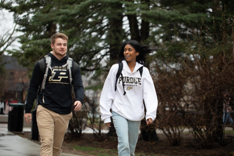two undergraduates walking together on campus