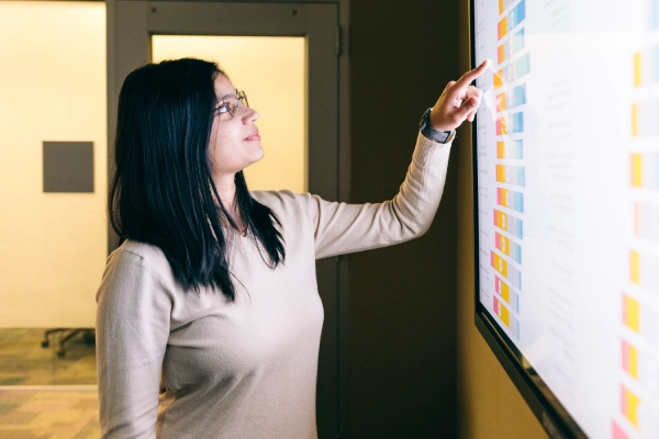 student examines data on large screen