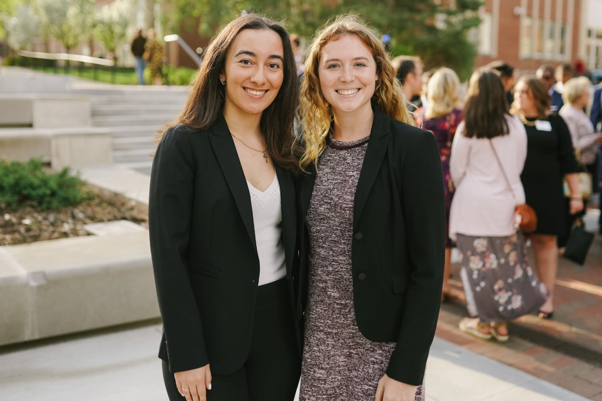 two smiling undergraduates at alumni event