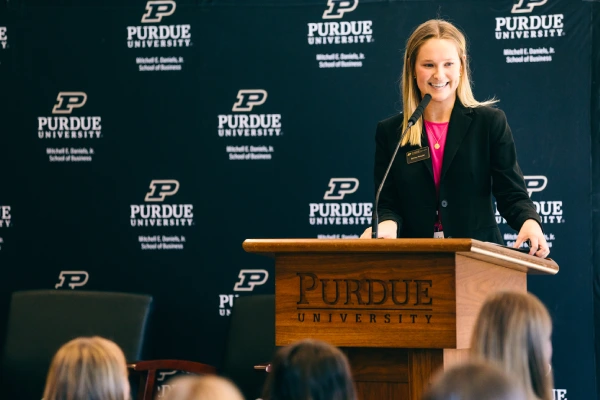 Speaker at podium smiling