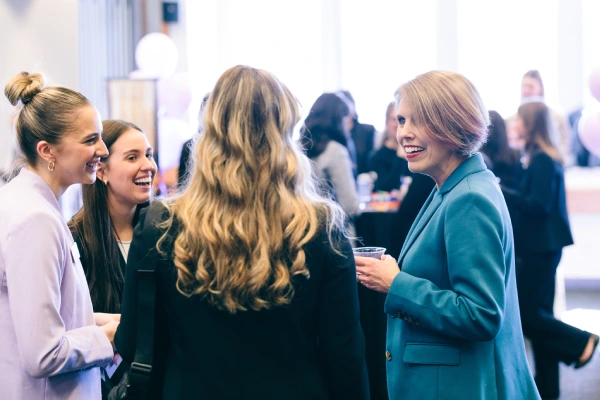 Attendees in conversation at event