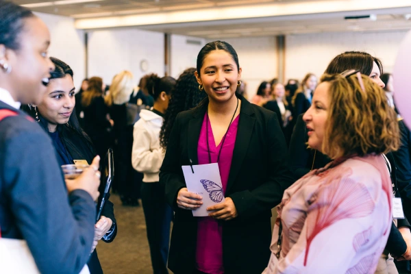 Attendees in conversation with professional