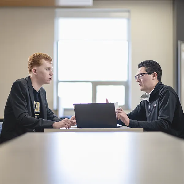 Two students discuss a presentation