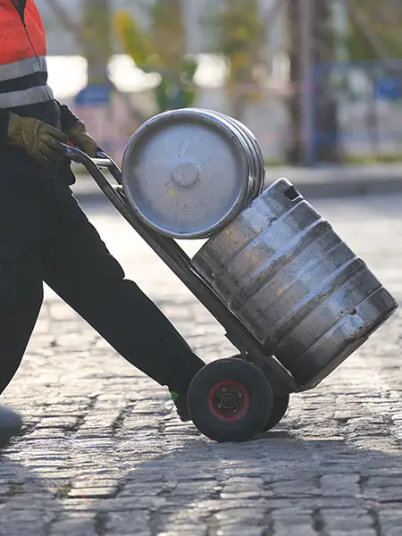 Worker transporting kegs of beer