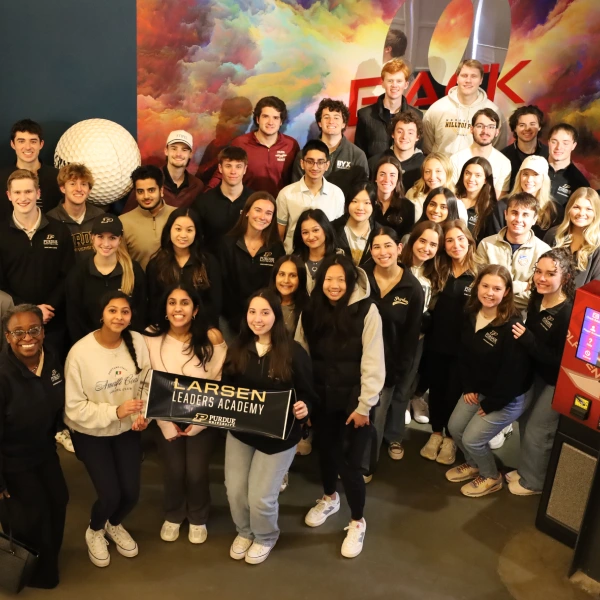 Large group of students holding Larsen sign