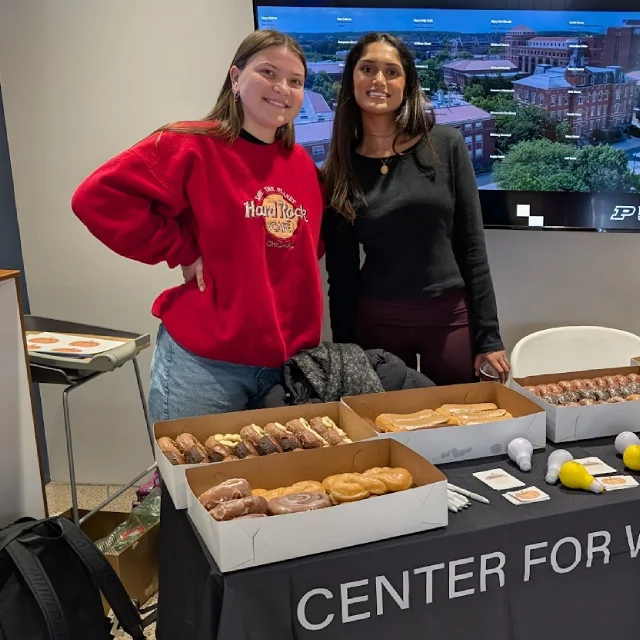 Two students working table at event