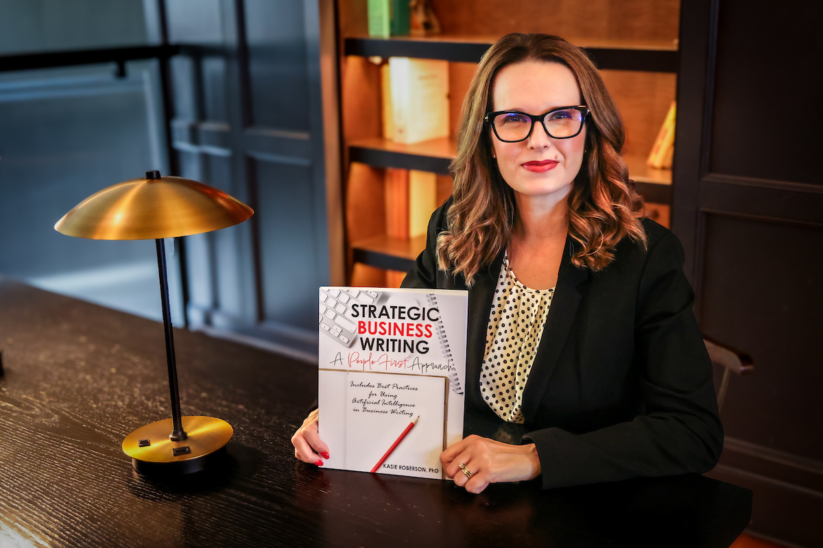 Kasie Roberson seated holding her book