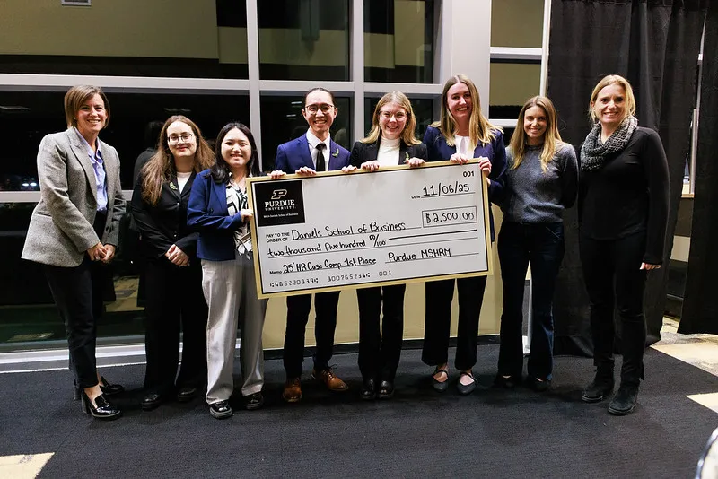Winning Daniels School holding oversized check at event