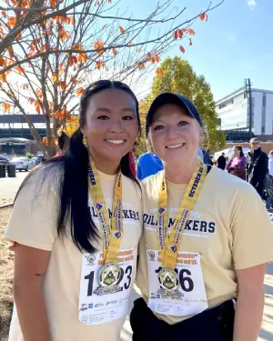 Lia with a friend at a marathon