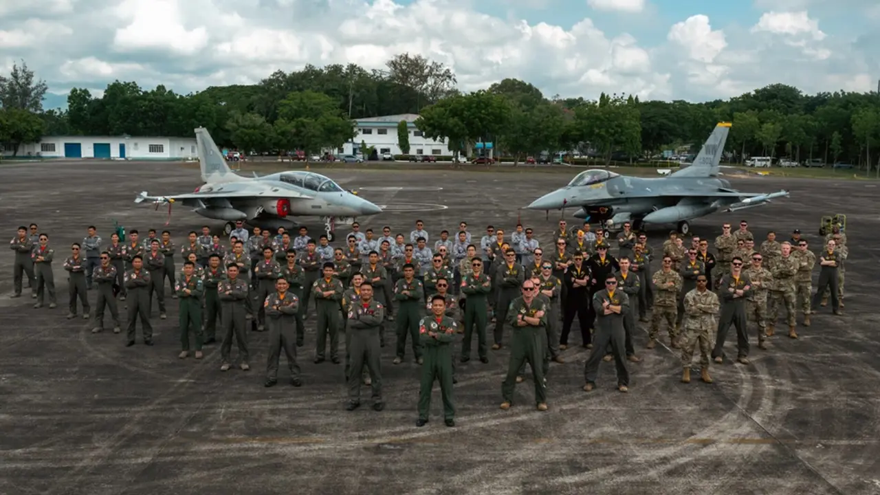 Air force members pose on tarmac