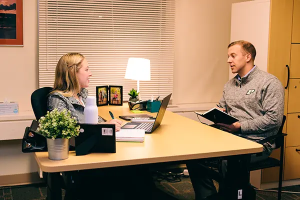 Two people talking in a office