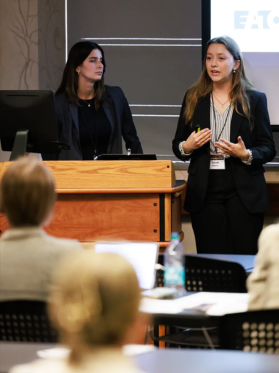 Two students giving a presentation at a case competition