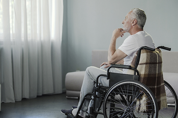 elderly man in wheelchair in nursing home