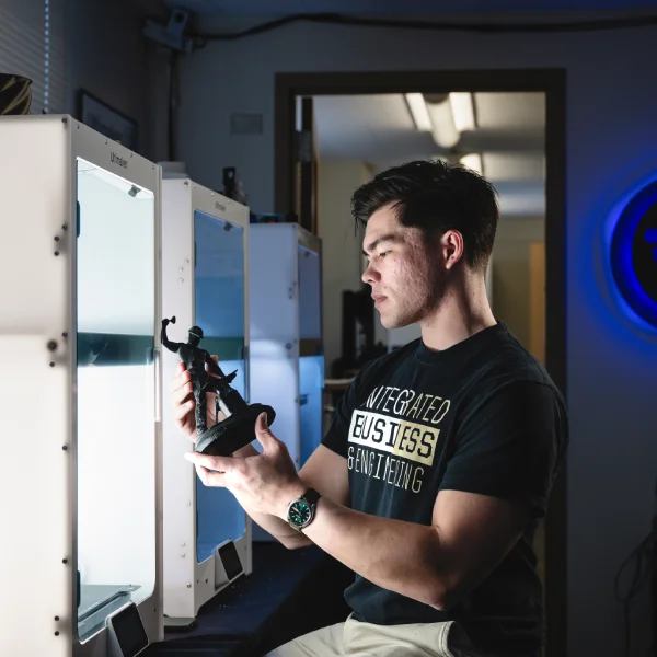 Daniels School student holds a 3D printed model of Purdue Boilermaker