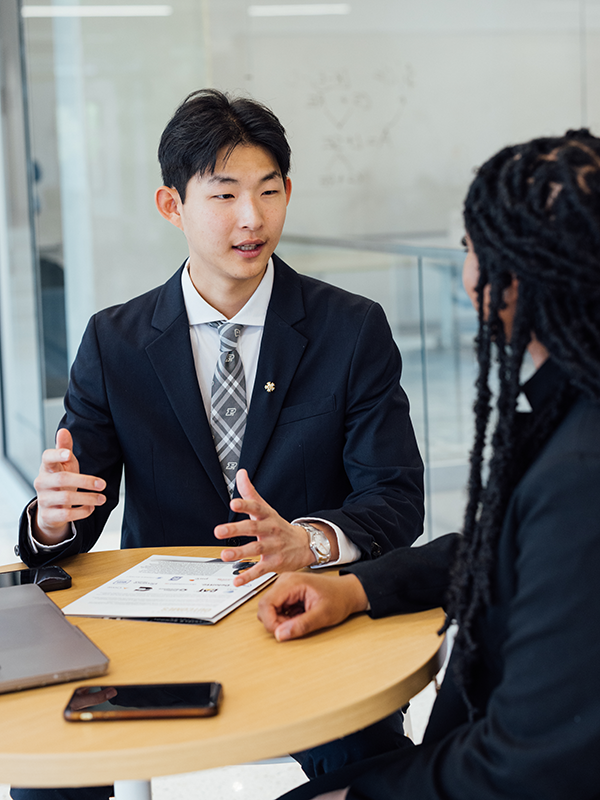 Man sitting at a desk in conversation