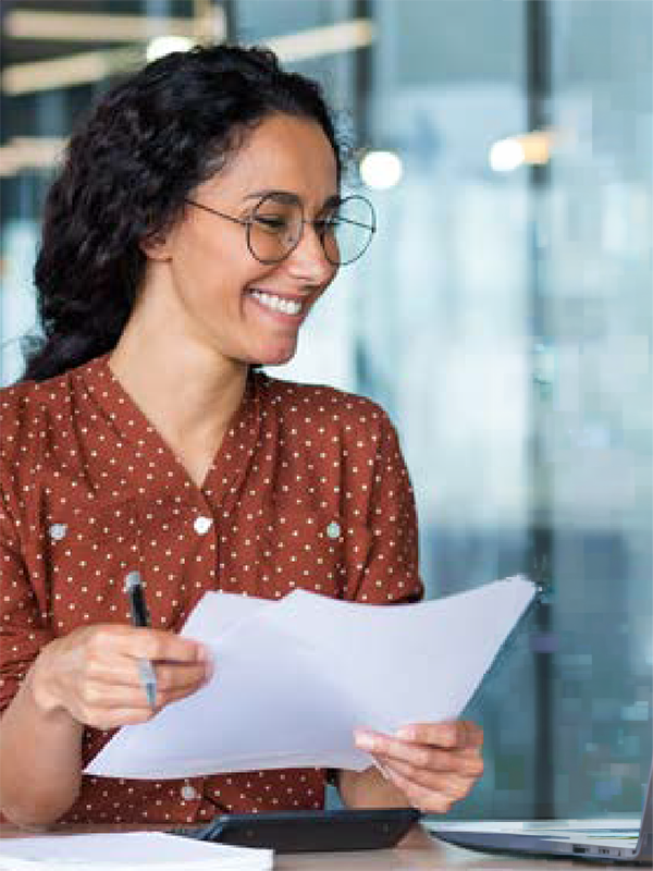 Woman smiling while holding paper