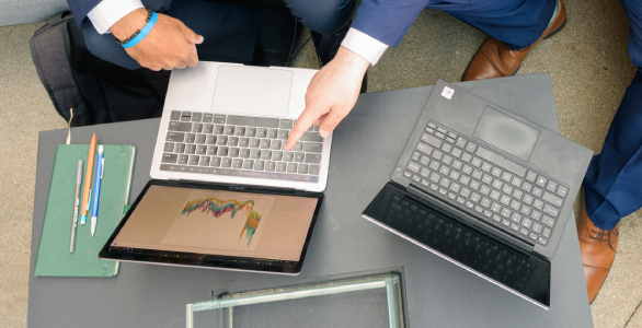 person pointing at laptop screen