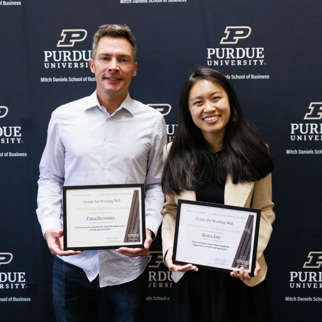 Gloria Liou and Tobias Dennerlein holding award