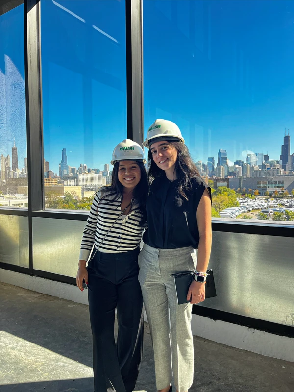 Filippa Rodriguez with friend wearing hard hats during site visit