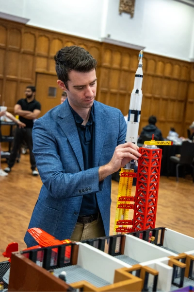 Tyler Clites building a model of the new business school building with LEGO blocks