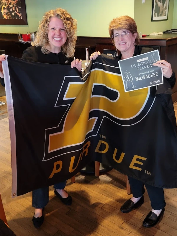 Leanne Bourdage and Liz Forman hold a Purdue flag