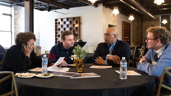 Four people collaborate at a Cornerstone for Business event