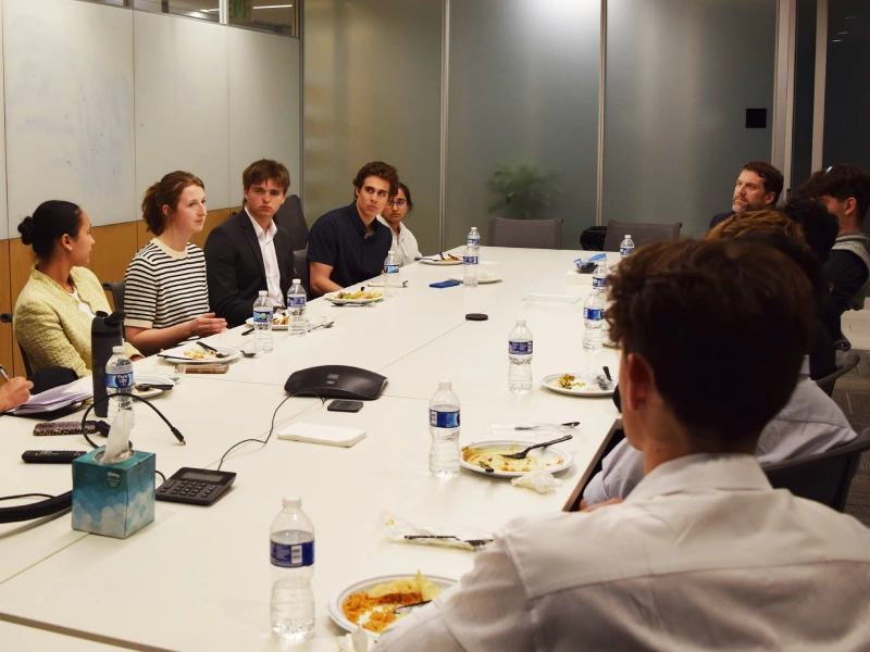 Claire Gertsmeier sharing meal with Dean V. White Real Estate Scholars. 