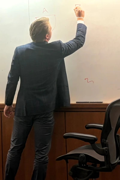 Clay Isacson writing on whiteboard
