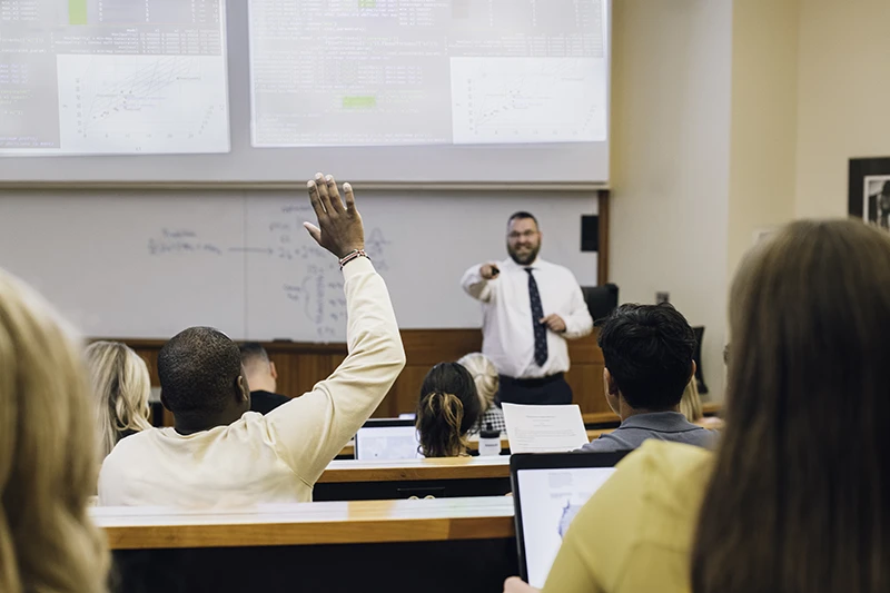 Student raising hand in class