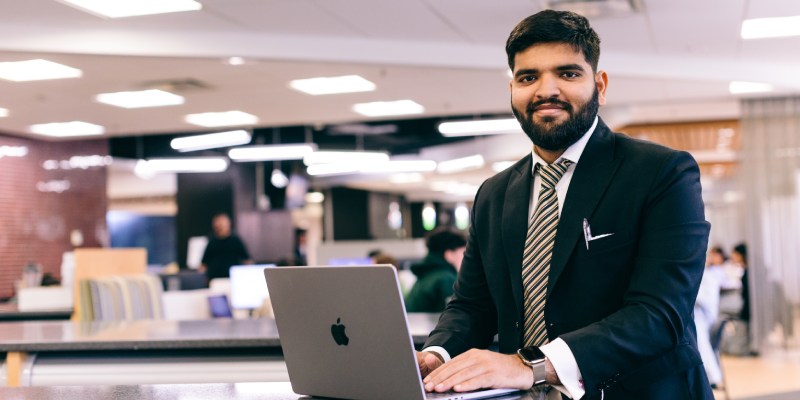 Happy student working at laptop
