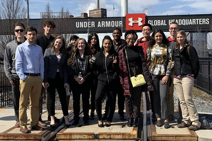 Students stand outside Under Armour clothing Global Headquaters