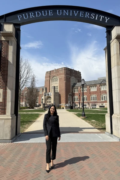 Ariana Diaz smiles beneath the Purdue University Gateway