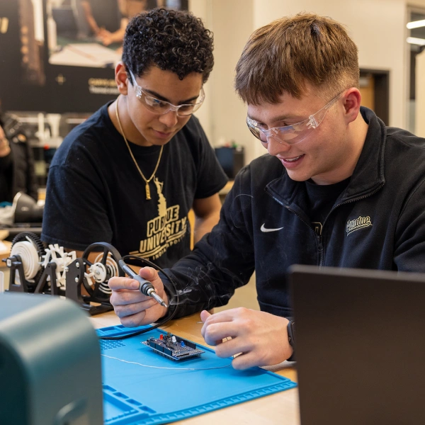 Blake Thomas with another student working on project in lab