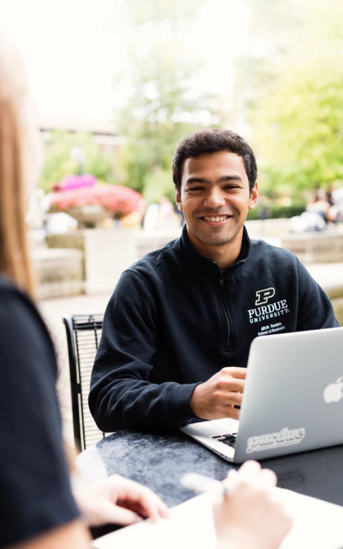 Smiling Daniels School student working on laptop