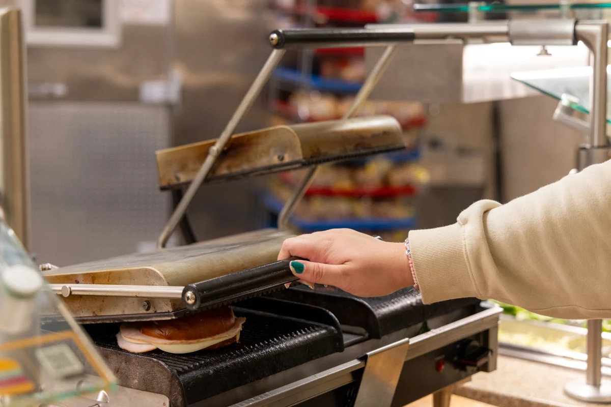 student using panini press