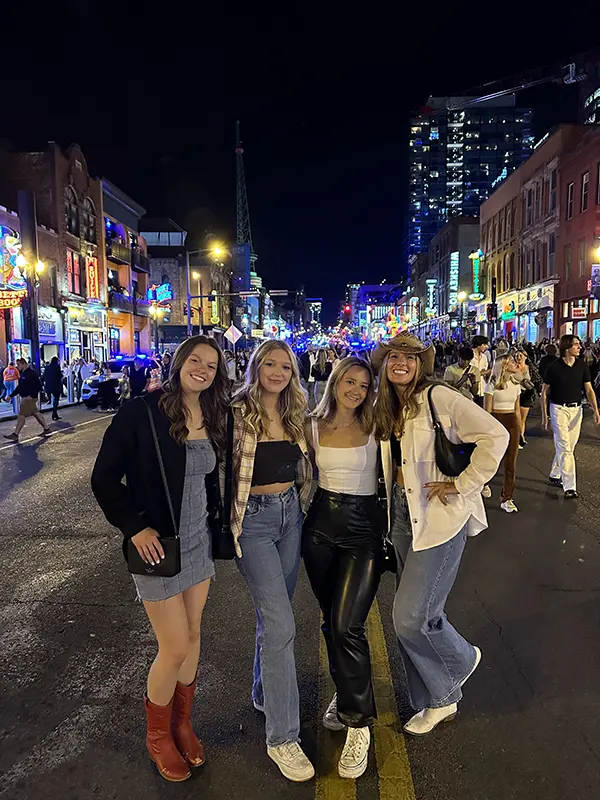 Bella (left) with friends on Broadway in Nashville