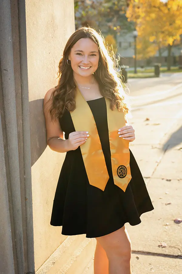 Alisha on graduation day outside of Elliot Hall of Music