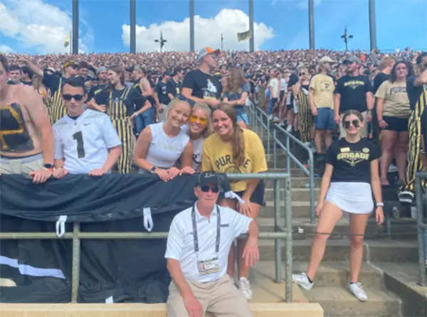 Alisha (right) with friends meeting former president, Mitch Daniels (bottom) at Ross-Ade Stadium