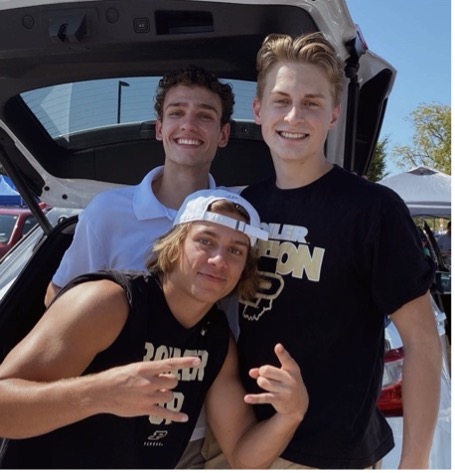 Mitchell (upper left) posing with friends 