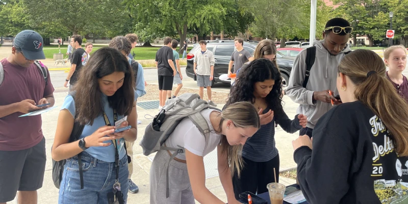 Students line up to sign their name