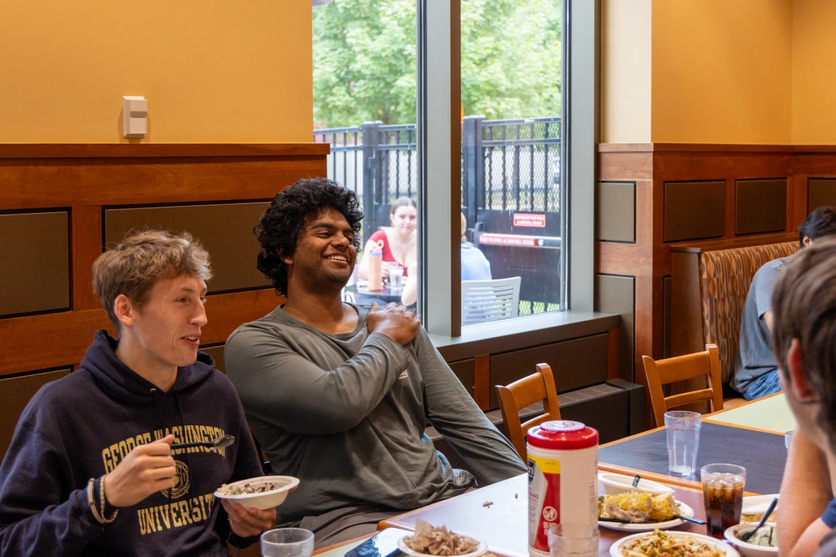 Students in conversation while eating together