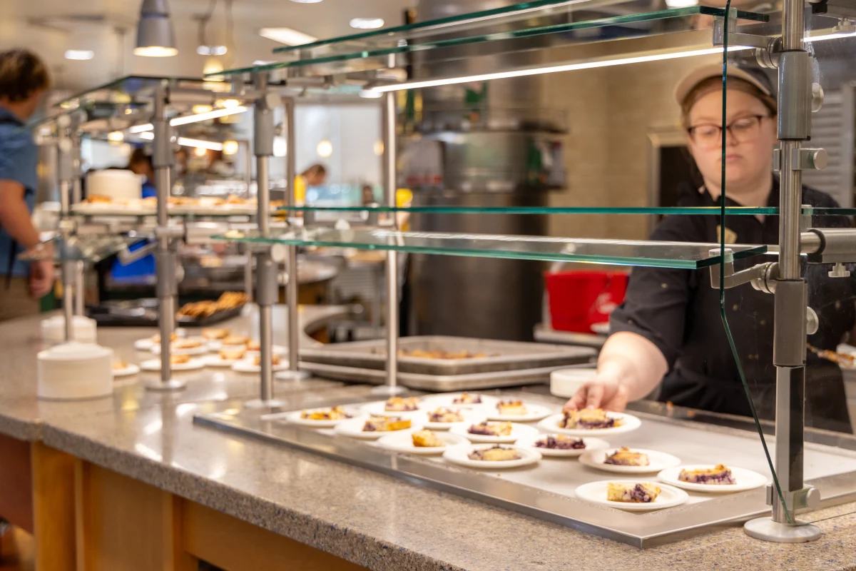 Worker placing slices of pie on counter